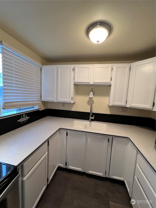 kitchen with sink, white cabinets, and dark hardwood / wood-style floors