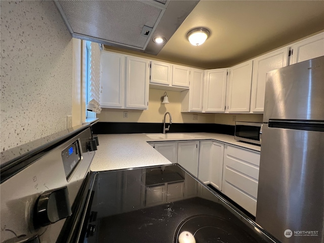 kitchen featuring sink, appliances with stainless steel finishes, and white cabinetry