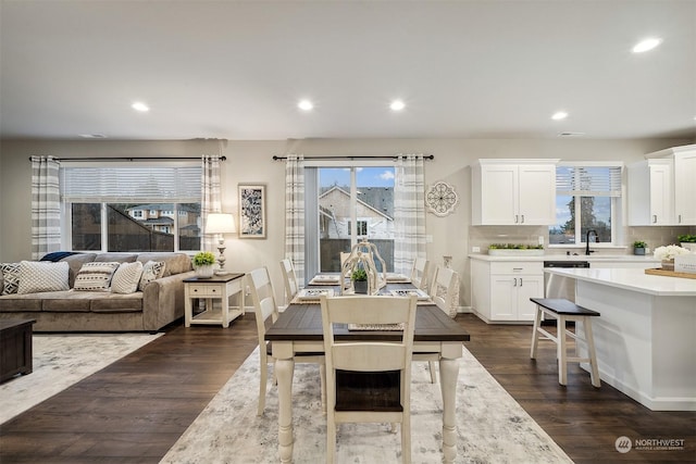 dining room with dark wood finished floors, plenty of natural light, and recessed lighting