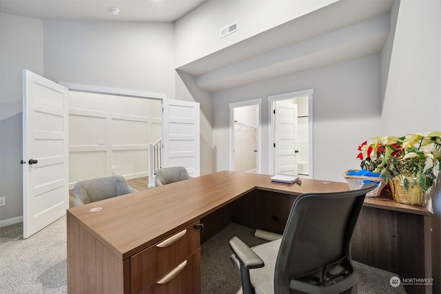 home office featuring visible vents and light carpet