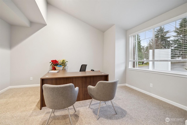 home office featuring baseboards, lofted ceiling, and carpet