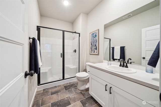 bathroom with visible vents, toilet, a stall shower, and vanity