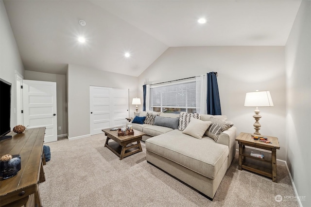 living room with vaulted ceiling and light colored carpet