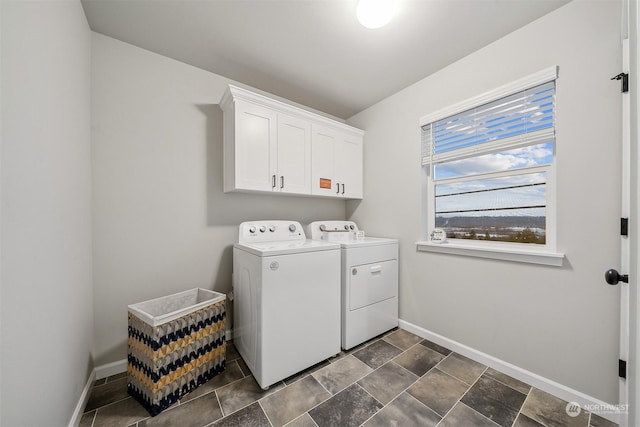 laundry room with washer and dryer, baseboards, and cabinet space