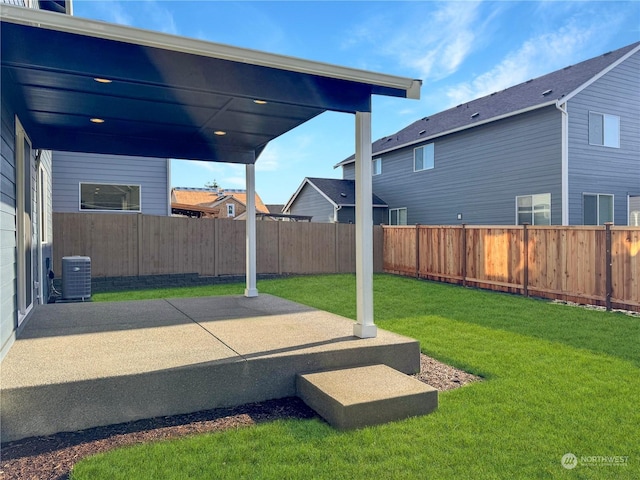 view of yard featuring a carport, central AC unit, a patio, and a fenced backyard