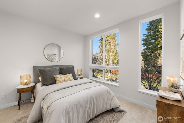 bedroom with recessed lighting, light colored carpet, and baseboards