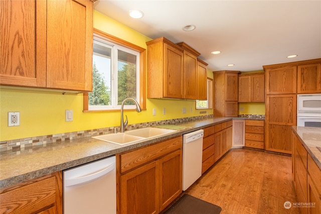 kitchen featuring light hardwood / wood-style floors, sink, and white appliances