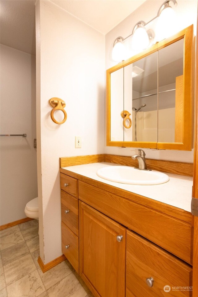 bathroom with vanity, toilet, and tile patterned flooring