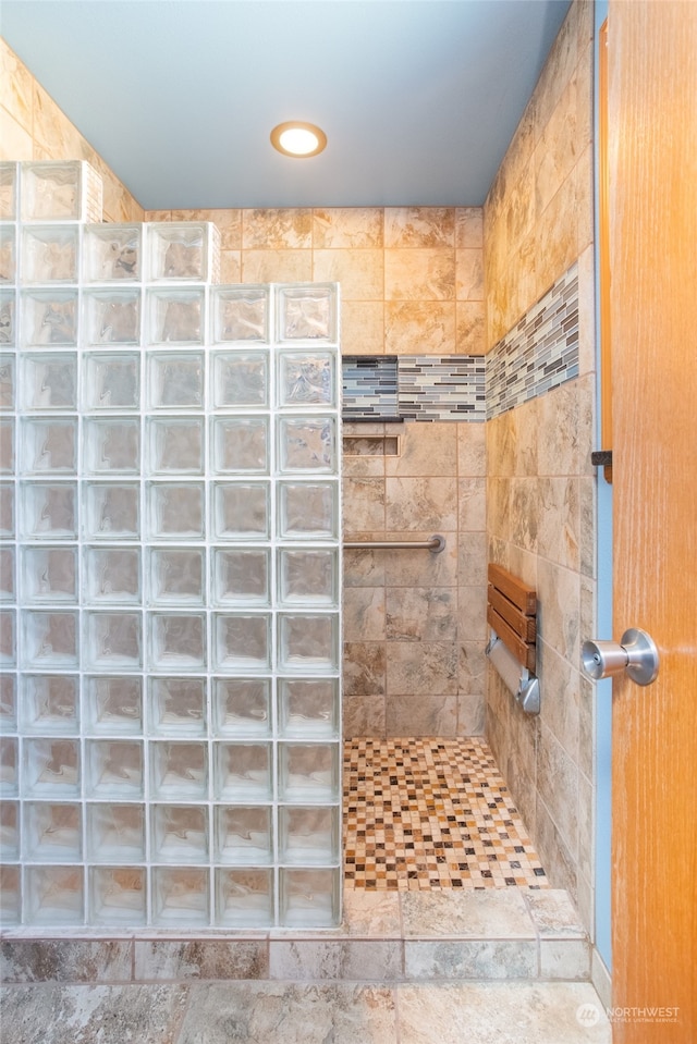 bathroom with a tile shower