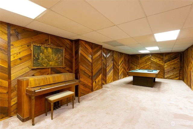 interior space featuring wood walls, carpet floors, a paneled ceiling, and billiards