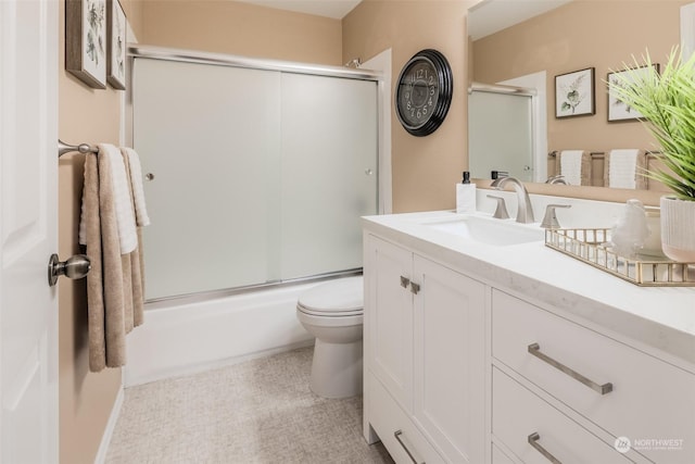 bathroom with vanity, toilet, and enclosed tub / shower combo