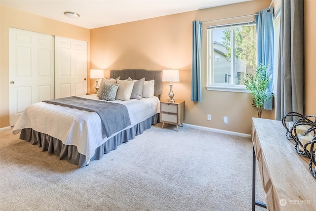 bedroom with a closet, baseboards, and carpet floors