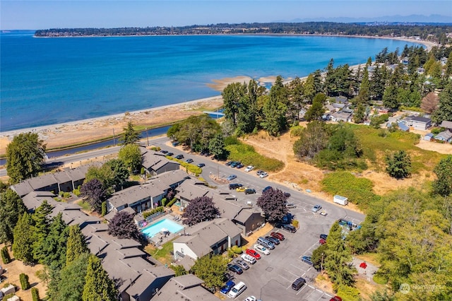 birds eye view of property featuring a water view and a view of the beach