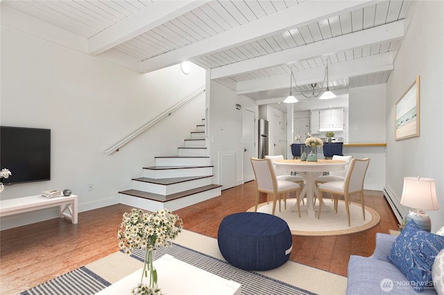 living room with hardwood / wood-style floors, beam ceiling, and a baseboard radiator