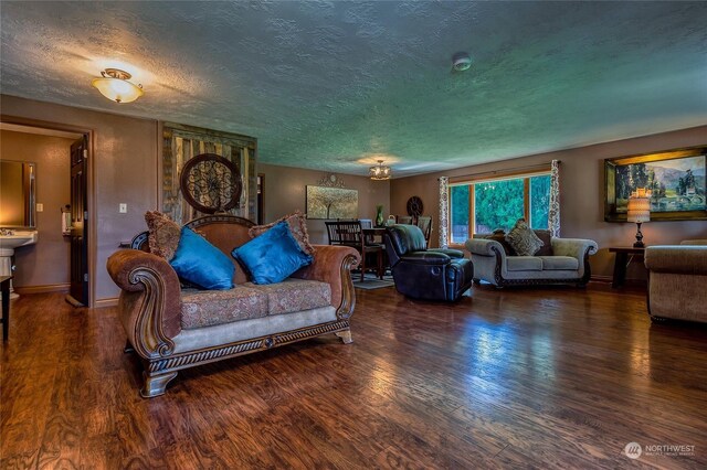 living room with dark hardwood / wood-style floors and a textured ceiling