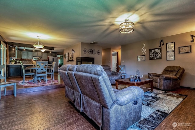 living room featuring dark hardwood / wood-style flooring and a textured ceiling