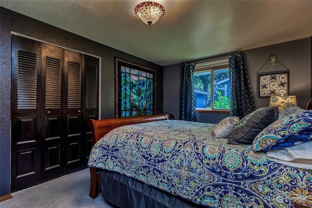 bedroom featuring carpet floors and a textured ceiling