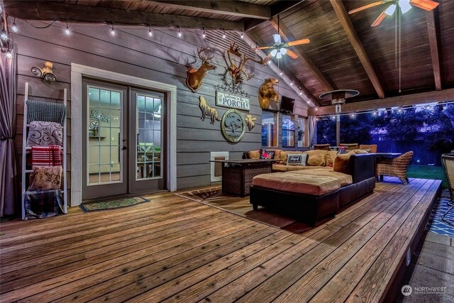 wooden deck with an outdoor hangout area and ceiling fan