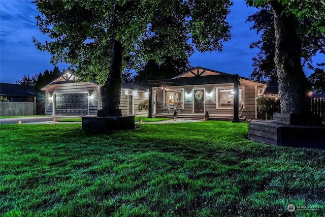 view of front of house featuring a garage, an outdoor structure, and a front lawn