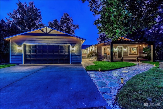 single story home featuring a garage and a front yard