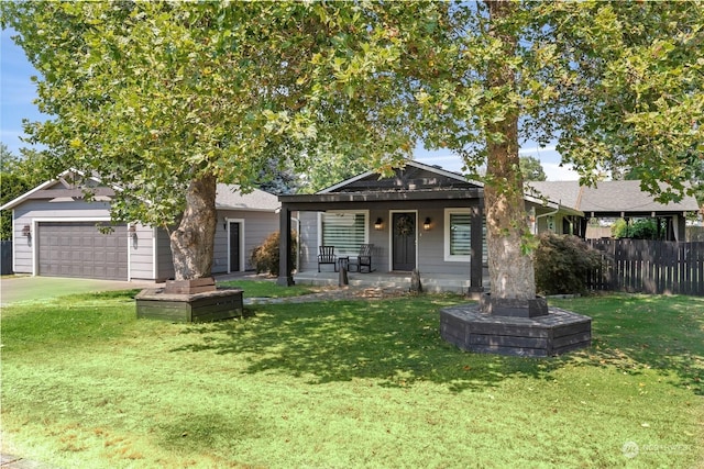 view of front of property featuring a garage and a front lawn