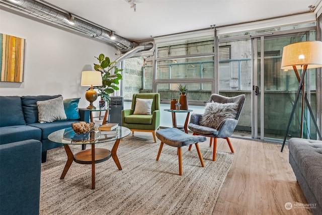 interior space with light wood-type flooring and expansive windows