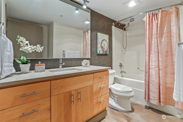 full bathroom with shower / bathtub combination with curtain, toilet, and vanity