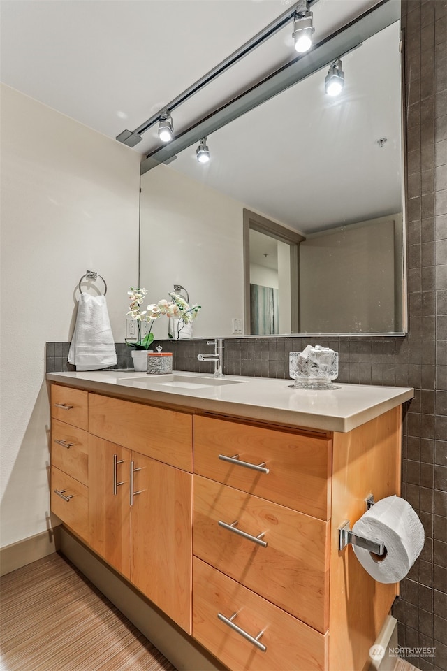 bathroom featuring tile walls, vanity, and decorative backsplash