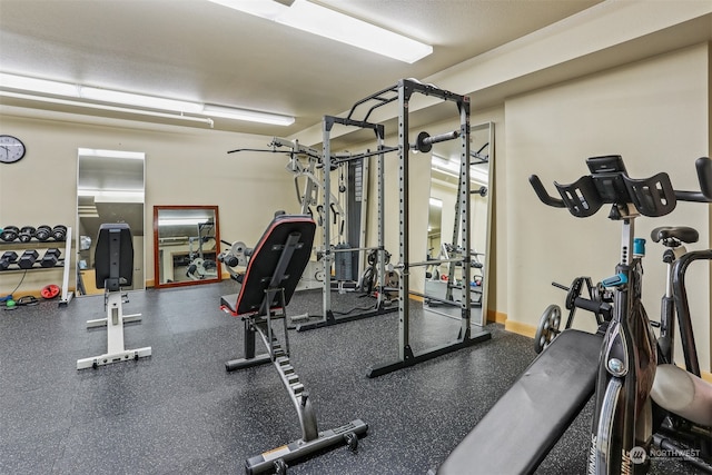 exercise room with a textured ceiling