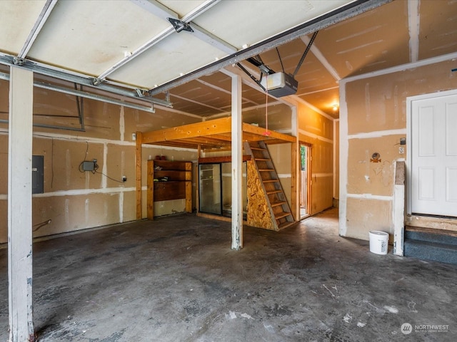 garage with electric panel and a garage door opener