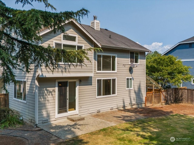 rear view of house with crawl space, a chimney, and fence