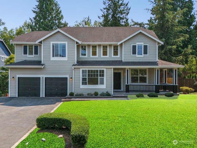 view of front of house featuring a garage, a porch, and a front yard