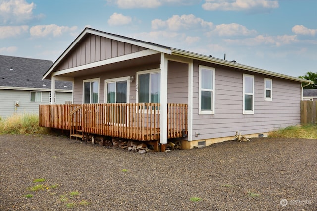 rear view of property featuring a deck