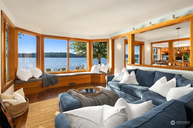 living room featuring a water view and hardwood / wood-style flooring