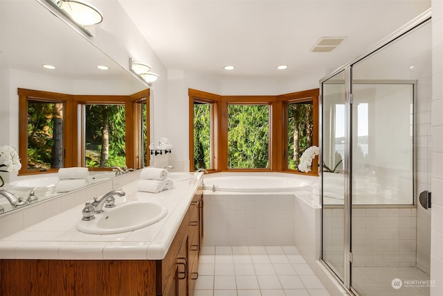 bathroom with tile patterned flooring, a healthy amount of sunlight, vanity, and independent shower and bath