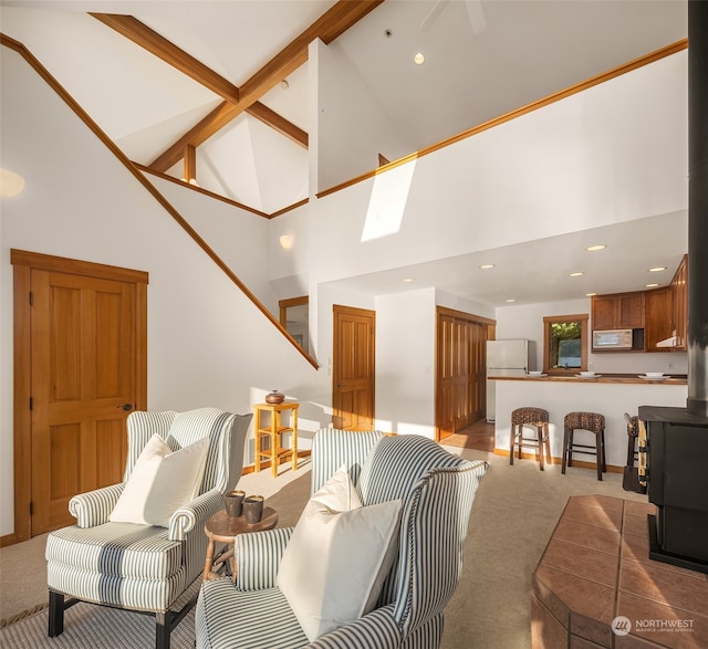 carpeted living room with beamed ceiling, high vaulted ceiling, and a wood stove