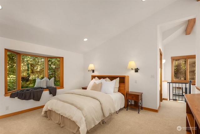 bedroom featuring lofted ceiling, multiple windows, and light carpet