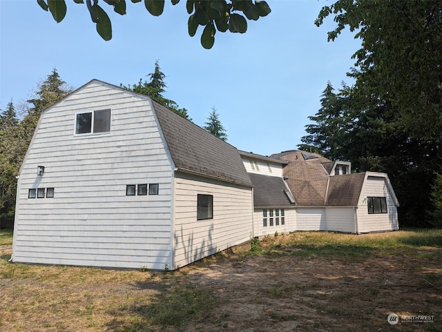 view of side of home with a storage unit