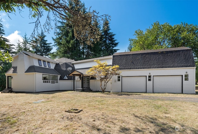 view of front facade with a front yard and a garage