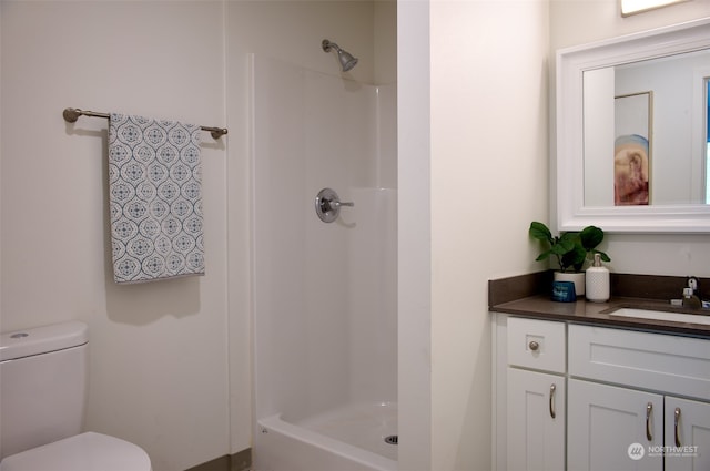 bathroom with vanity, walk in shower, and toilet