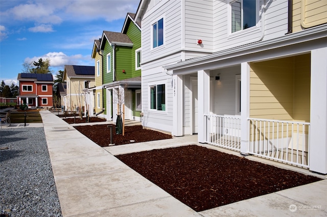 exterior space featuring covered porch and solar panels