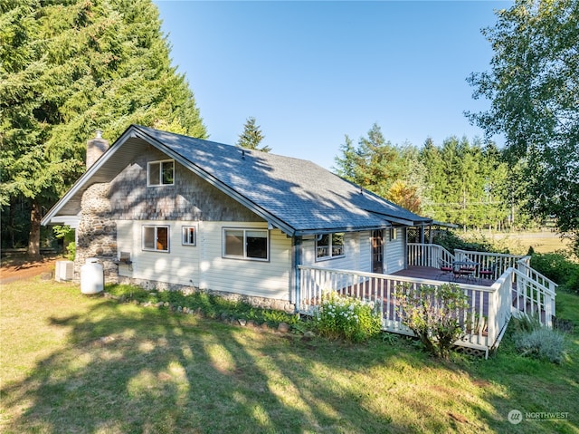 exterior space featuring a lawn and a deck