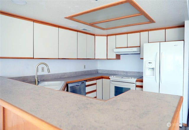 kitchen featuring white appliances, a sink, white cabinetry, and under cabinet range hood