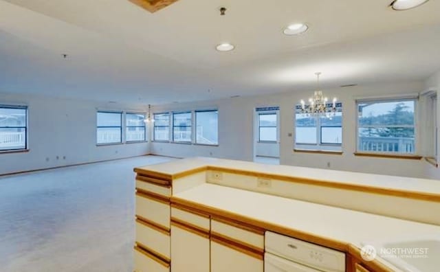 kitchen featuring recessed lighting, pendant lighting, light countertops, and open floor plan