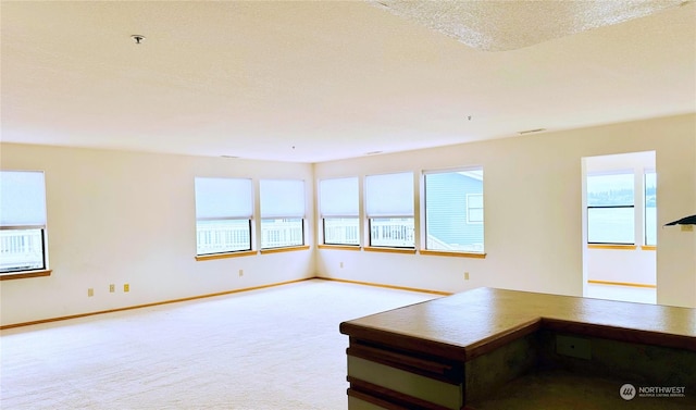 interior space with a textured ceiling and baseboards