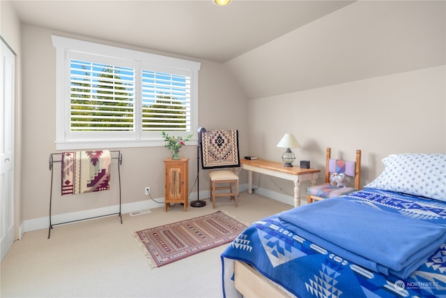 carpeted bedroom with vaulted ceiling