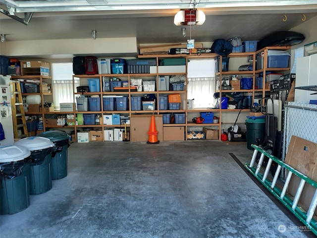 garage with a workshop area and a garage door opener