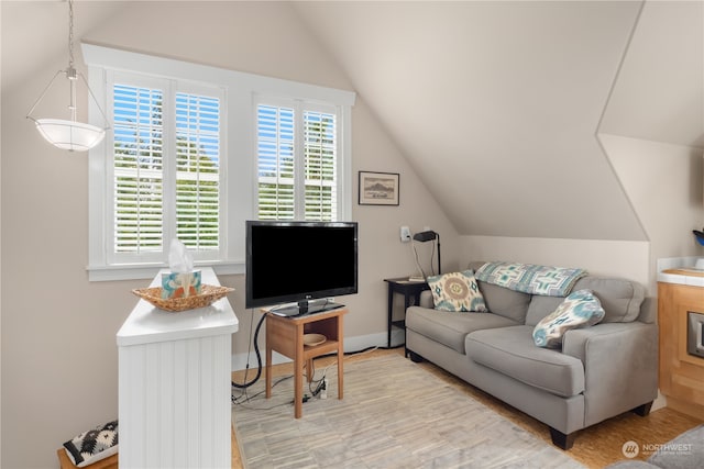 living room with light hardwood / wood-style flooring and vaulted ceiling