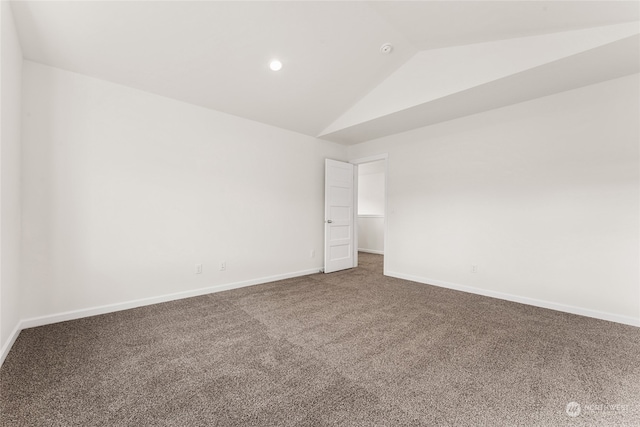 unfurnished room with vaulted ceiling and carpet