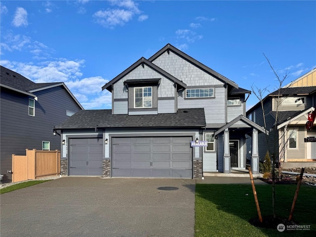 view of front of property with a garage and a front lawn